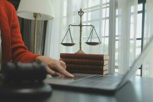 Business and lawyers discussing contract papers with brass scale on desk in office. Law, legal services, advice, justice and law concept picture with film grain effect photo