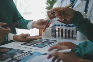 Medical technology network team meeting concept. Doctor hand working smart phone modern digital tablet laptop computer graphics chart interface, sun beams effect photo