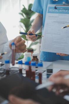 Medical technology network team meeting concept. Doctor hand working smart phone modern digital tablet laptop computer graphics chart interface, sun beams effect photo