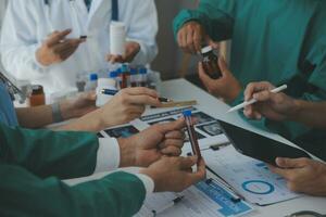 Medical technology network team meeting concept. Doctor hand working smart phone modern digital tablet laptop computer graphics chart interface, sun beams effect photo