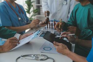 Medical technology network team meeting concept. Doctor hand working smart phone modern digital tablet laptop computer graphics chart interface, sun beams effect photo