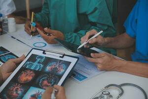 Medical technology network team meeting concept. Doctor hand working smart phone modern digital tablet laptop computer graphics chart interface, sun beams effect photo