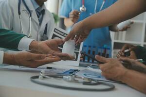 Medical technology network team meeting concept. Doctor hand working smart phone modern digital tablet laptop computer graphics chart interface, sun beams effect photo