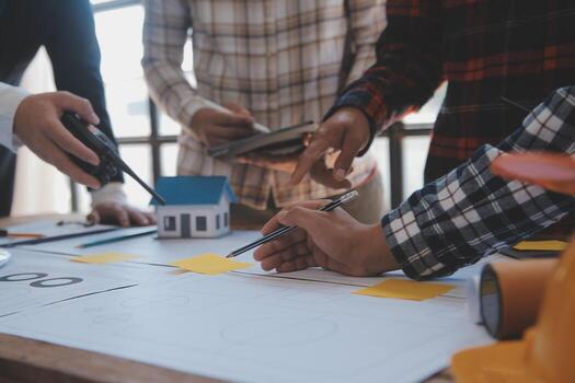 Engineer Teamwork Meeting, Drawing working on blueprint meeting for project working with partner on model building and engineering tools in working site, Construction and structure concept. photo