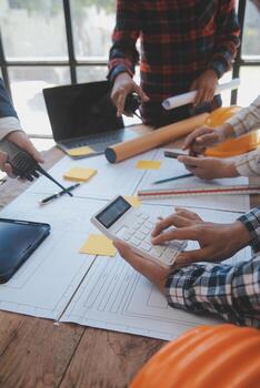 Engineer Teamwork Meeting, Drawing working on blueprint meeting for project working with partner on model building and engineering tools in working site, Construction and structure concept. photo