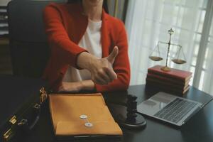 Business and lawyers discussing contract papers with brass scale on desk in office. Law, legal services, advice, justice and law concept picture with film grain effect photo