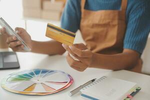 Retail, credit card payment service. Customer paying for order of cheese in grocery shop. photo