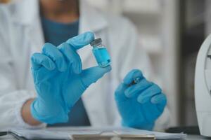 Professional lab. Amazing longhaired medical worker wearing uniform while using microscope during research photo