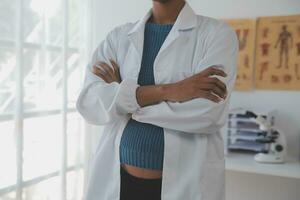 Professional lab. Amazing longhaired medical worker wearing uniform while using microscope during research photo