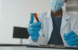 Professional lab. Amazing longhaired medical worker wearing uniform while using microscope during research photo