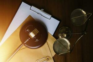 Justice and law concept.Male judge in a courtroom with the gavel, working with, computer and docking keyboard, eyeglasses, on table in morning light photo