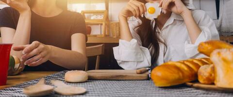 Laughing group of diverse young woman hanging out at home together and eating pizza photo