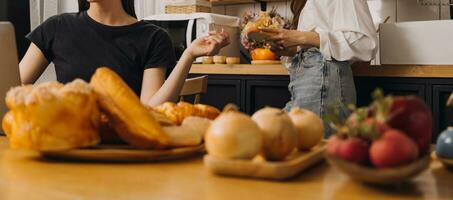 Laughing group of diverse young woman hanging out at home together and eating pizza photo