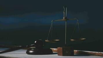 Justice and law concept.Male judge in a courtroom with the gavel, working with, computer and docking keyboard, eyeglasses, on table in morning light video