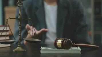 Justice and law concept.Male judge in a courtroom with the gavel, working with, computer and docking keyboard, eyeglasses, on table in morning light video