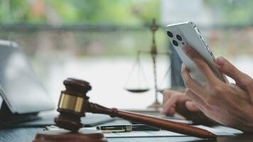 Justice and law concept.Male judge in a courtroom with the gavel, working with, computer and docking keyboard, eyeglasses, on table in morning light video