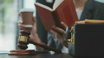 Justice and law concept.Male judge in a courtroom with the gavel, working with, computer and docking keyboard, eyeglasses, on table in morning light video