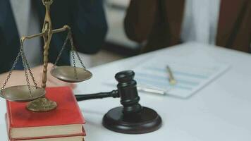 Justice and law concept.Male judge in a courtroom with the gavel, working with, computer and docking keyboard, eyeglasses, on table in morning light video