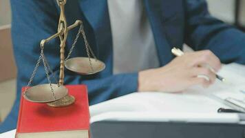 Justice and law concept.Male judge in a courtroom with the gavel, working with, computer and docking keyboard, eyeglasses, on table in morning light video