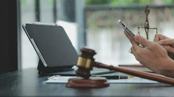 Justice and law concept.Male judge in a courtroom with the gavel, working with, computer and docking keyboard, eyeglasses, on table in morning light video