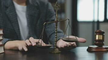 Justice and law concept.Male judge in a courtroom with the gavel, working with, computer and docking keyboard, eyeglasses, on table in morning light video