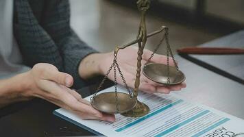 Justice and law concept.Male judge in a courtroom with the gavel, working with, computer and docking keyboard, eyeglasses, on table in morning light video