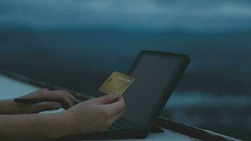 online payment, young woman holding credit card and typing on laptop video