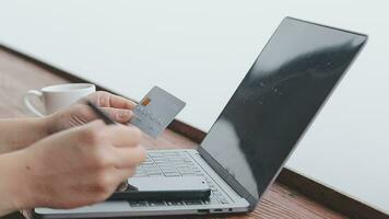 online payment, young woman holding credit card and typing on laptop video