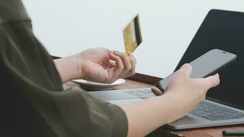 online payment, young woman holding credit card and typing on laptop video