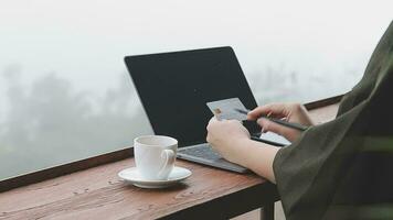 online payment, young woman holding credit card and typing on laptop video