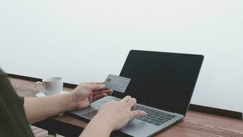 online payment, young woman holding credit card and typing on laptop video