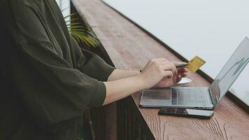 online payment, young woman holding credit card and typing on laptop video