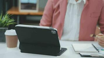 Financial analysts analyze business financial reports on a digital tablet planning investment project during a discussion at a meeting of corporate showing the results of their successful teamwork. video