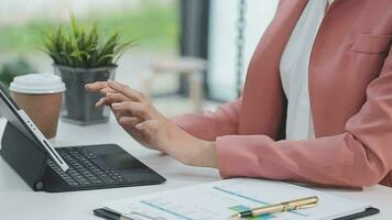 Financial analysts analyze business financial reports on a digital tablet planning investment project during a discussion at a meeting of corporate showing the results of their successful teamwork. video