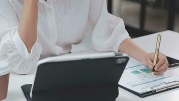 Financial analysts analyze business financial reports on a digital tablet planning investment project during a discussion at a meeting of corporate showing the results of their successful teamwork. video