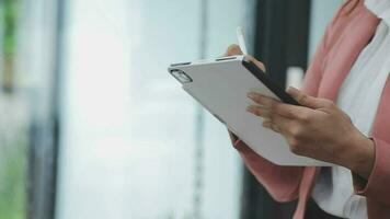 Financial analysts analyze business financial reports on a digital tablet planning investment project during a discussion at a meeting of corporate showing the results of their successful teamwork. video