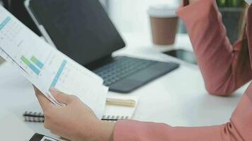 Financial analysts analyze business financial reports on a digital tablet planning investment project during a discussion at a meeting of corporate showing the results of their successful teamwork. video