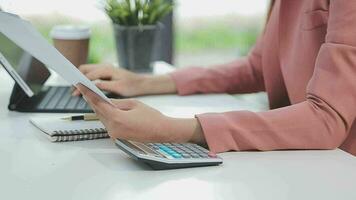 Financial analysts analyze business financial reports on a digital tablet planning investment project during a discussion at a meeting of corporate showing the results of their successful teamwork. video