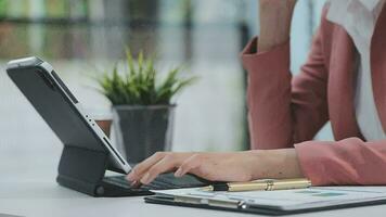 Financial analysts analyze business financial reports on a digital tablet planning investment project during a discussion at a meeting of corporate showing the results of their successful teamwork. video