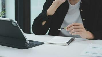 Financial analysts analyze business financial reports on a digital tablet planning investment project during a discussion at a meeting of corporate showing the results of their successful teamwork. video