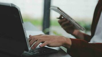 Financial analysts analyze business financial reports on a digital tablet planning investment project during a discussion at a meeting of corporate showing the results of their successful teamwork. video