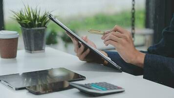 Financial analysts analyze business financial reports on a digital tablet planning investment project during a discussion at a meeting of corporate showing the results of their successful teamwork. video