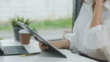 Financial analysts analyze business financial reports on a digital tablet planning investment project during a discussion at a meeting of corporate showing the results of their successful teamwork. video