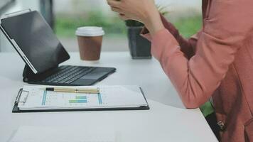 Financial analysts analyze business financial reports on a digital tablet planning investment project during a discussion at a meeting of corporate showing the results of their successful teamwork. video