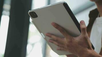 Financial analysts analyze business financial reports on a digital tablet planning investment project during a discussion at a meeting of corporate showing the results of their successful teamwork. video