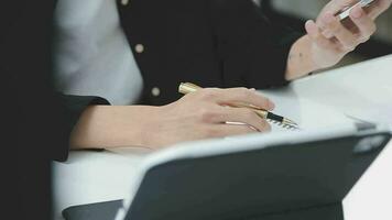 Financial analysts analyze business financial reports on a digital tablet planning investment project during a discussion at a meeting of corporate showing the results of their successful teamwork. video