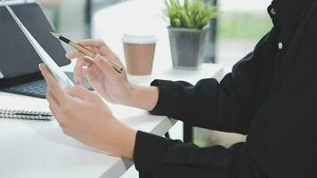 Financial analysts analyze business financial reports on a digital tablet planning investment project during a discussion at a meeting of corporate showing the results of their successful teamwork. video