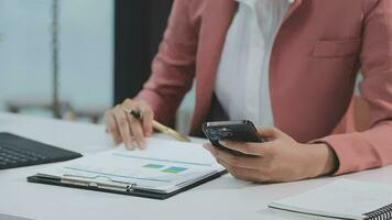 Financial analysts analyze business financial reports on a digital tablet planning investment project during a discussion at a meeting of corporate showing the results of their successful teamwork. video