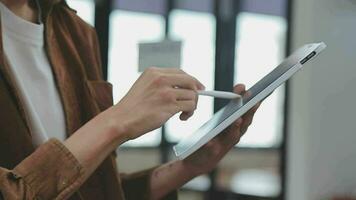 Financial analysts analyze business financial reports on a digital tablet planning investment project during a discussion at a meeting of corporate showing the results of their successful teamwork. video