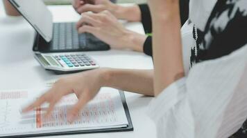 Financial analysts analyze business financial reports on a digital tablet planning investment project during a discussion at a meeting of corporate showing the results of their successful teamwork. video